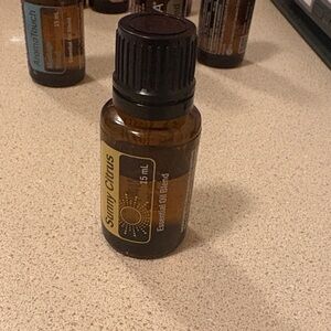 Doterra Sunny Citrus Essential Oil - Brown and Black